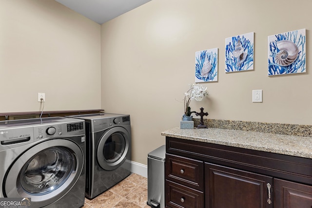 770 Tralee Dr, Fayetteville, GA 30215 - laundry area with baseboards, washing machine and dryer, light tile patterned flooring, and cabinet space