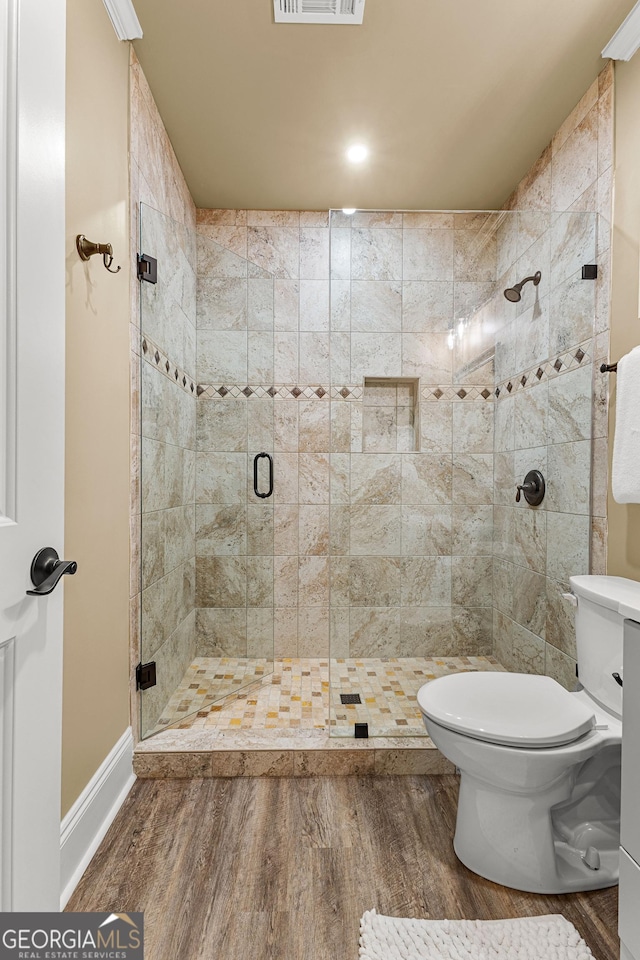 770 Tralee Dr, Fayetteville, GA 30215 - full bathroom featuring a stall shower, baseboards, toilet, visible vents, and wood finished floors