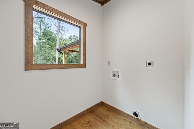 laundry area with baseboards, hookup for a washing machine, wood finished floors, hookup for an electric dryer, and laundry area