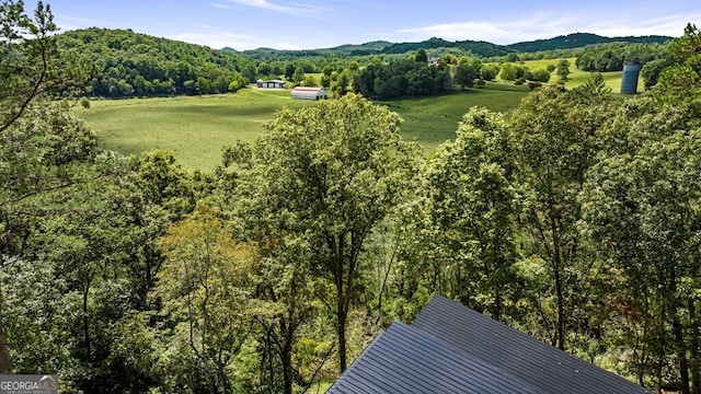 exterior space featuring a wooded view and a mountain view