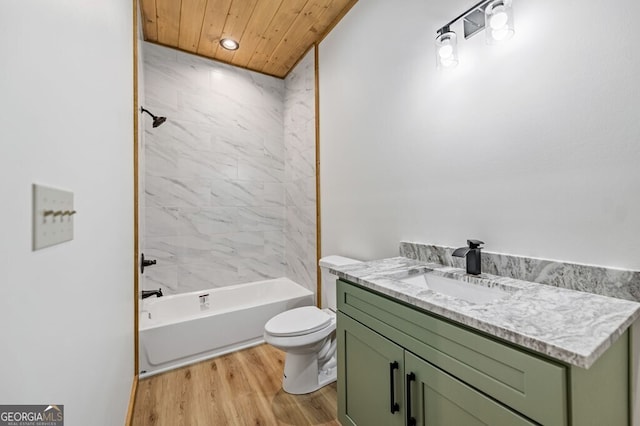 bathroom featuring toilet, wood finished floors, washtub / shower combination, vanity, and recessed lighting
