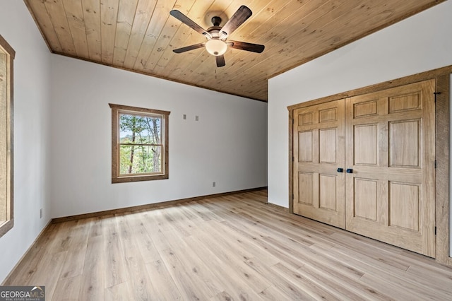 unfurnished bedroom with wooden ceiling, light wood finished floors, a closet, and a ceiling fan