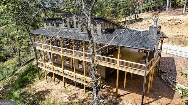 exterior space featuring metal roof, a wooden deck, and board and batten siding