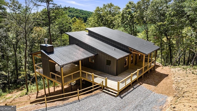 exterior space featuring a wooded view