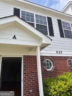 exterior space with brick siding