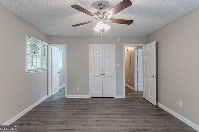 4089 Lindsey Dr, Decatur, GA 30035 - unfurnished bedroom featuring a ceiling fan, a closet, a textured ceiling, dark wood-type flooring, and baseboards