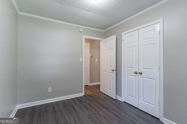 4089 Lindsey Dr, Decatur, GA 30035 - unfurnished bedroom with a closet, dark wood finished floors, a textured ceiling, baseboards, and ornamental molding