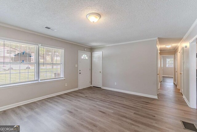 4089 Lindsey Dr, Decatur, GA 30035 - entryway featuring ornamental molding, a textured ceiling, visible vents, and wood finished floors
