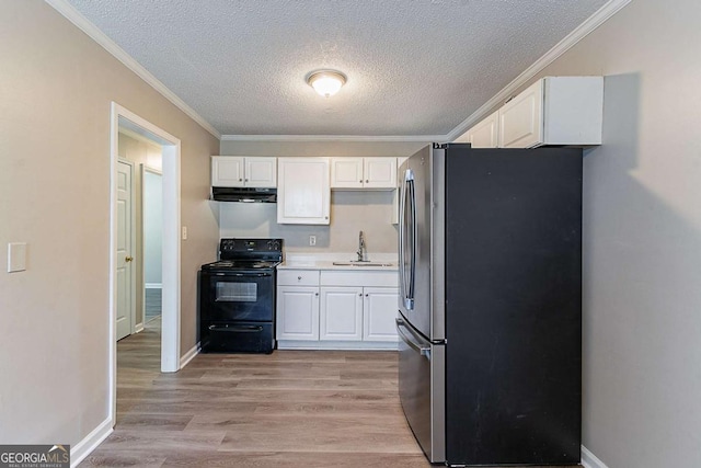 4089 Lindsey Dr, Decatur, GA 30035 - kitchen with a sink, freestanding refrigerator, white cabinets, exhaust hood, and black electric range oven