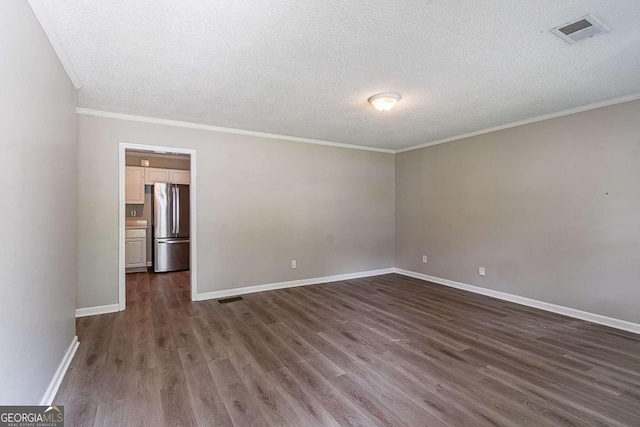 4089 Lindsey Dr, Decatur, GA 30035 - unfurnished room featuring a textured ceiling, dark wood-style floors, and visible vents