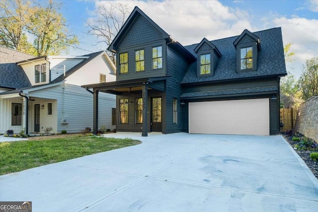 view of front facade with driveway, fence, a shingled roof, a porch, and a front lawn