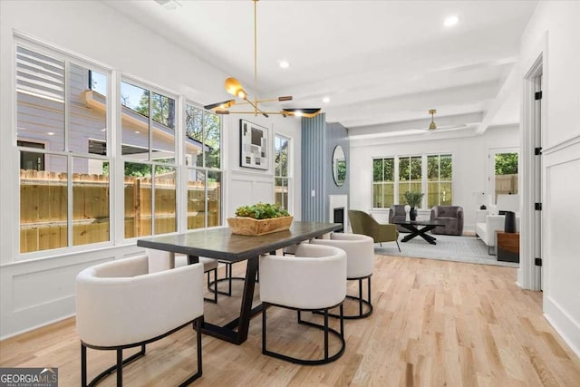 dining space featuring light wood finished floors, beam ceiling, a notable chandelier, baseboards, and recessed lighting