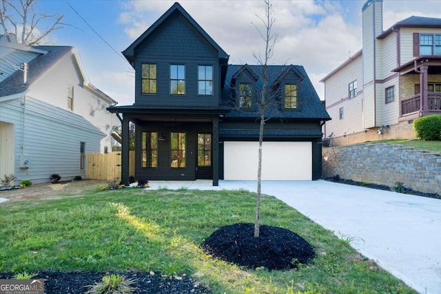 view of front of house featuring a porch, fence, an attached garage, concrete driveway, and a front lawn