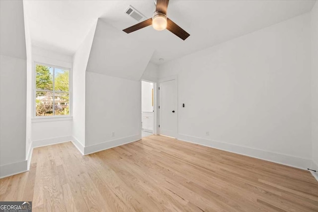 unfurnished bedroom with light wood finished floors, a ceiling fan, visible vents, baseboards, and ensuite bath