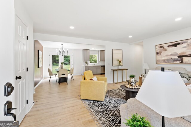 living room featuring a chandelier, light wood-style flooring, and recessed lighting