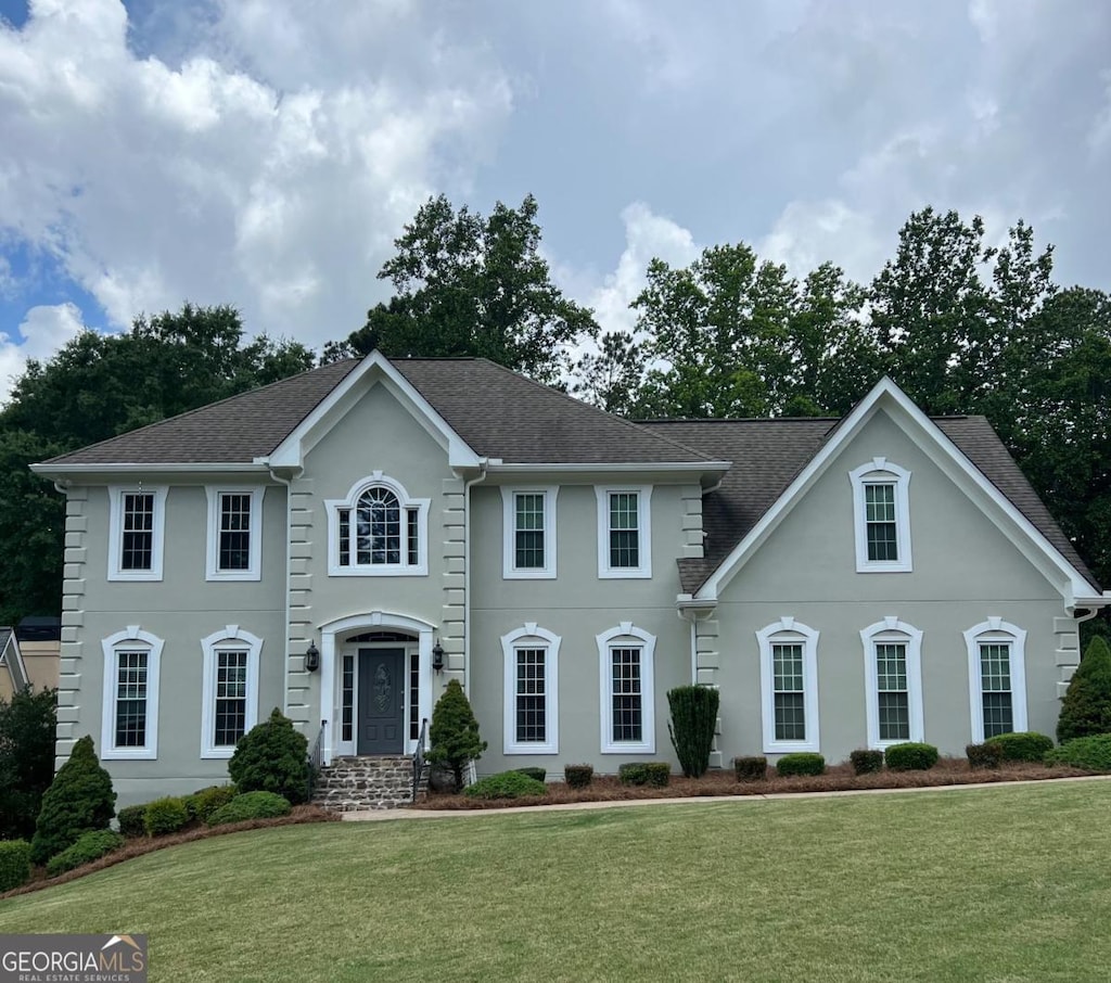 3330 Arborwoods Dr, Alpharetta, GA 30022 - colonial inspired home featuring stucco siding, a front lawn, and roof with shingles