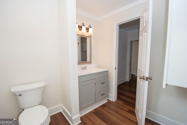31 Saint Clair St, Newnan, GA 30263 - half bath featuring wood finished floors, toilet, vanity, and baseboards