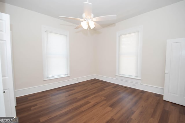 31 Saint Clair St, Newnan, GA 30263 - empty room with dark wood finished floors, a ceiling fan, healthy amount of natural light, and baseboards