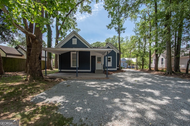 31 Saint Clair St, Newnan, GA 30263 - view of front facade featuring fence, gravel driveway, and a porch