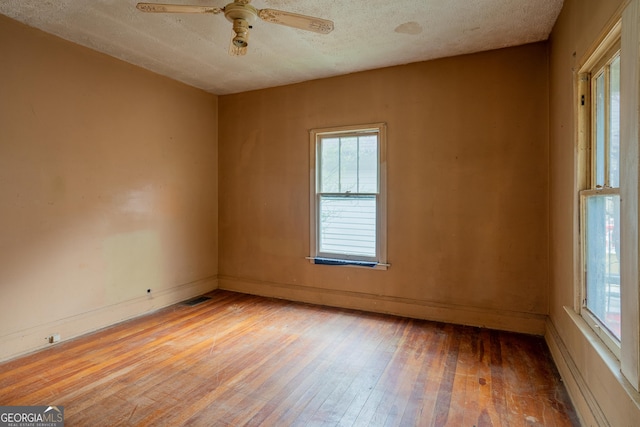 1388 Metropolitan Ave SE, Atlanta, GA 30316 - spare room featuring a ceiling fan, light wood-type flooring, visible vents, baseboards, and a textured ceiling