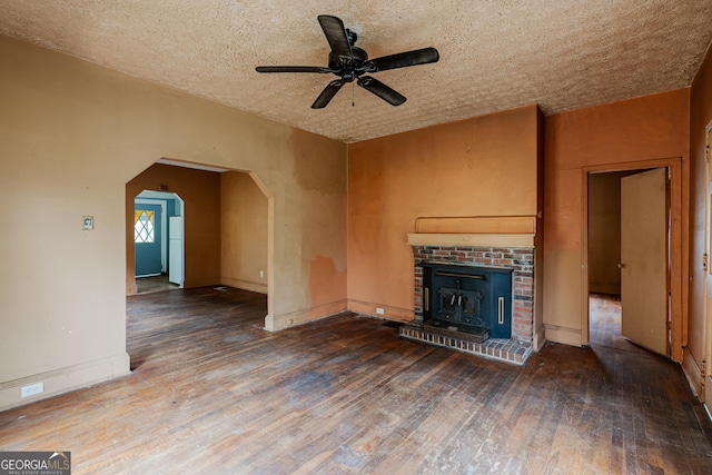 1388 Metropolitan Ave SE, Atlanta, GA 30316 - unfurnished living room featuring wood finished floors, a brick fireplace, arched walkways, a ceiling fan, and baseboards