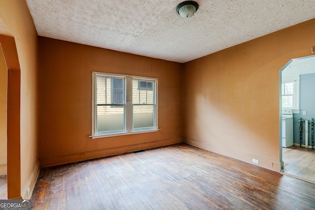 1388 Metropolitan Ave SE, Atlanta, GA 30316 - unfurnished room with hardwood / wood-style flooring, arched walkways, baseboards, and visible vents