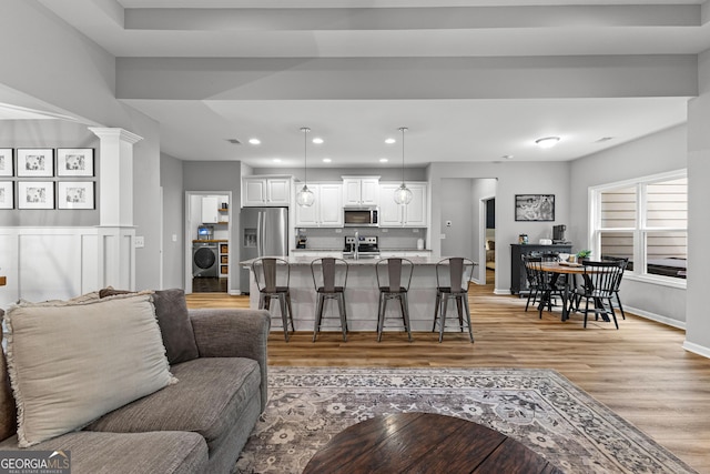 88 Carl Williams Rd, Senoia, GA 30276 - living room featuring washer / clothes dryer, light wood-style flooring, recessed lighting, and baseboards