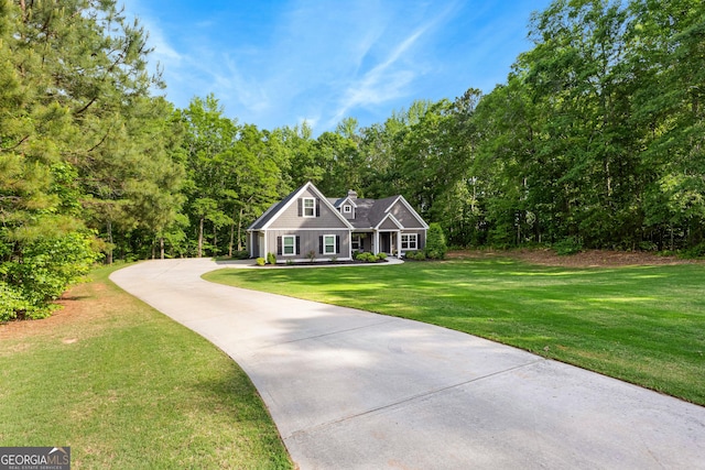 88 Carl Williams Rd, Senoia, GA 30276 - view of front facade featuring driveway, a front lawn, and a wooded view