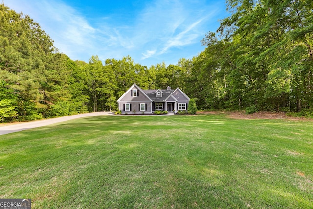 88 Carl Williams Rd, Senoia, GA 30276 - view of front of house featuring a front lawn, a view of trees, and a chimney