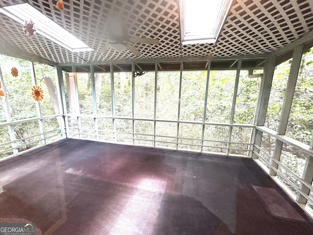 unfurnished sunroom featuring ceiling fan and a skylight
