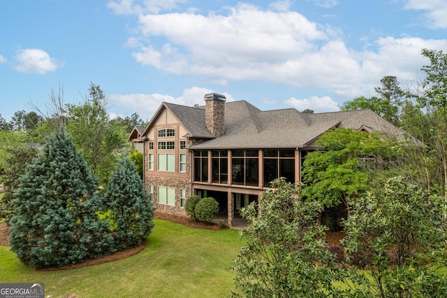 350 Greystone Dr, Milledgeville, GA 31061 - back of house with a sunroom, roof with shingles, a chimney, and a lawn