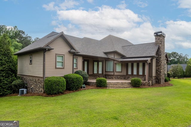 350 Greystone Dr, Milledgeville, GA 31061 - back of property with central air condition unit, stone siding, a yard, a chimney, and a shingled roof