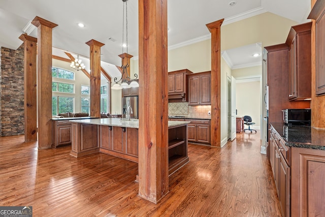 350 Greystone Dr, Milledgeville, GA 31061 - kitchen featuring wood finished floors, dark stone countertops, open shelves, decorative backsplash, and lofted ceiling