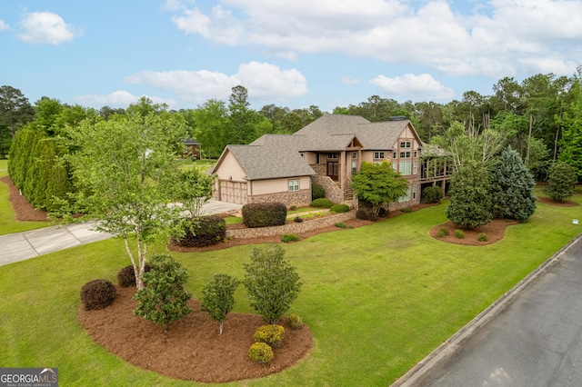 350 Greystone Dr, Milledgeville, GA 31061 - tudor house featuring concrete driveway, a front lawn, and stone siding