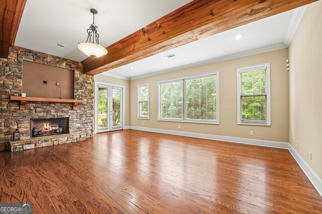 350 Greystone Dr, Milledgeville, GA 31061 - unfurnished living room featuring beam ceiling, wood finished floors, baseboards, and a stone fireplace