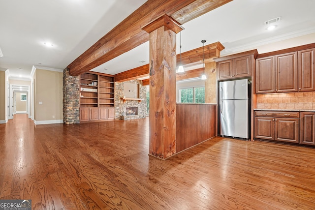 350 Greystone Dr, Milledgeville, GA 31061 - kitchen featuring freestanding refrigerator, a stone fireplace, ornamental molding, visible vents, and wood finished floors