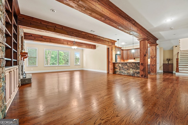 350 Greystone Dr, Milledgeville, GA 31061 - unfurnished living room featuring beam ceiling, stairway, baseboards, and dark wood-style floors