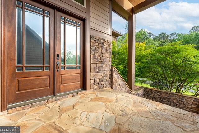 350 Greystone Dr, Milledgeville, GA 31061 - property entrance with stone siding, a patio, and french doors