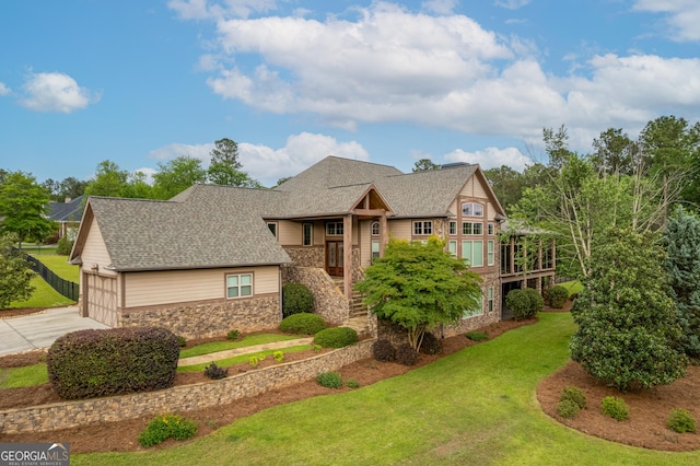 350 Greystone Dr, Milledgeville, GA 31061 - craftsman-style house featuring an attached garage, stone siding, concrete driveway, a front yard, and a shingled roof