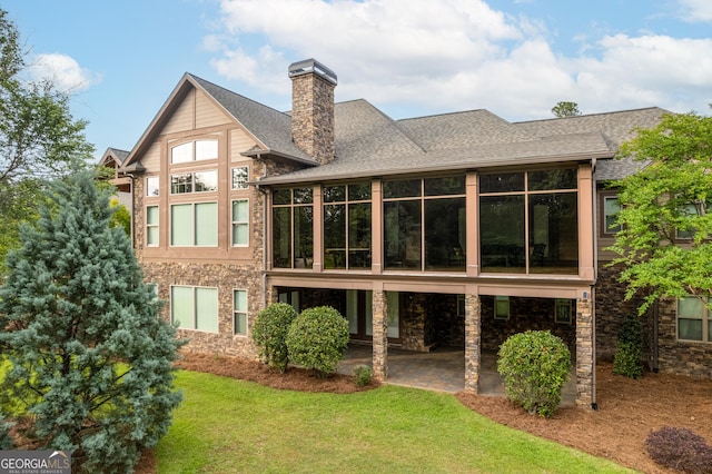 350 Greystone Dr, Milledgeville, GA 31061 - rear view of house featuring a chimney, a lawn, a patio area, a sunroom, and stone siding