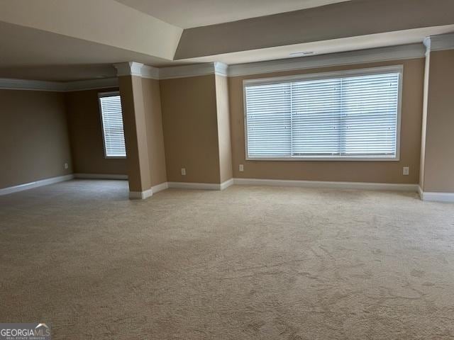 empty room with baseboards and light colored carpet