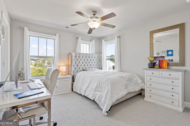 bedroom featuring light colored carpet, a ceiling fan, and visible vents