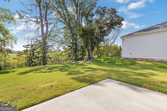 view of yard featuring a patio and fence
