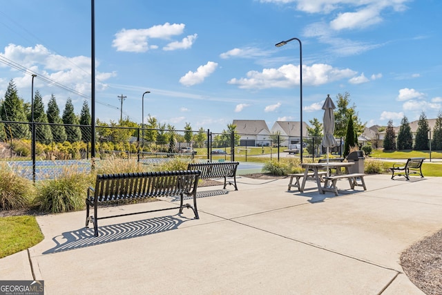 view of property's community with a residential view and fence