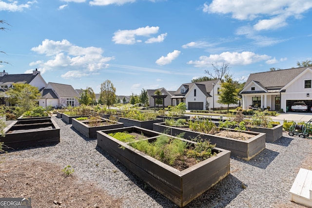 view of yard featuring a vegetable garden and a residential view