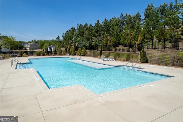 pool featuring a patio area and fence