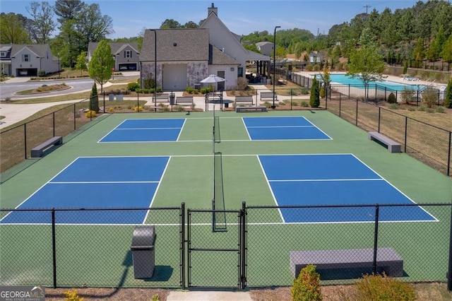 view of tennis court with a gate, fence, and community basketball court