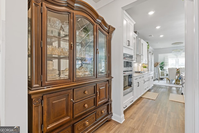 interior space with appliances with stainless steel finishes, visible vents, light wood-style flooring, and recessed lighting