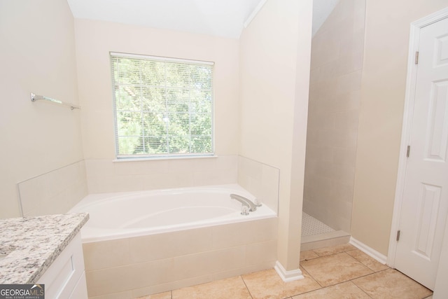 full bathroom with a bath, tile patterned flooring, and a tile shower