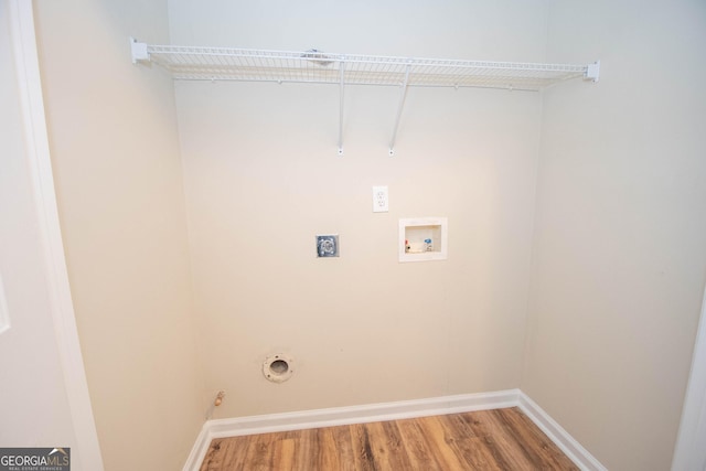 laundry room featuring wood finished floors, electric dryer hookup, laundry area, hookup for a washing machine, and baseboards